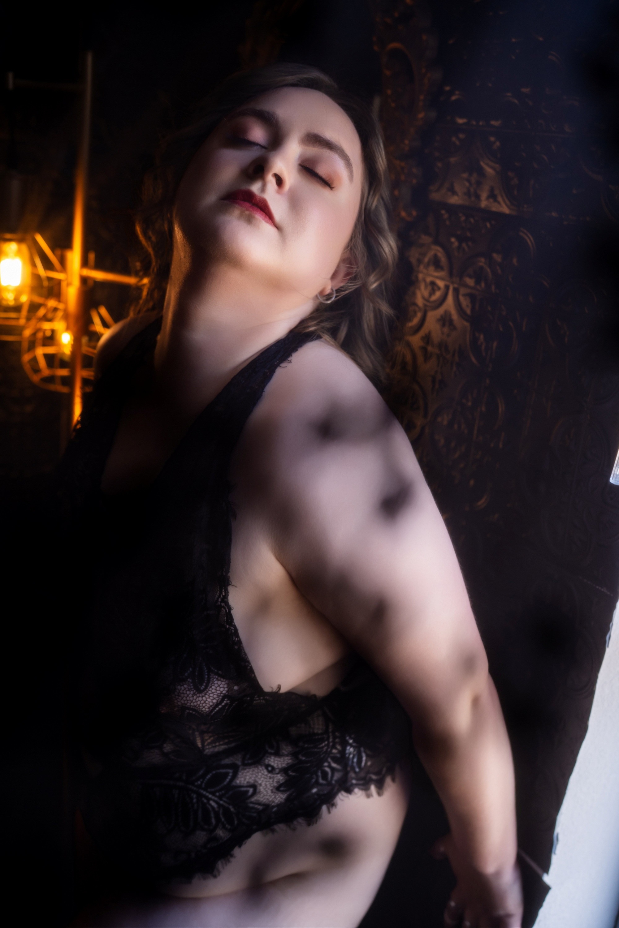 Jesse, a young blonde curvy escort in black lingerie. Credit: Luna Sanchez, Boudoir by Hannah Rose.